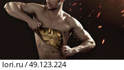 Golden guy tearing up his chest. Стоковое фото, агентство Ingram Publishing / Фотобанк Лори