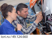 mechanic repairs the carburetor of his motorcycle. Стоковое фото, агентство Ingram Publishing / Фотобанк Лори