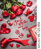Valentines day greeting card with love symbols , red decoration and roses and handwritten lettering Just you and my,  top view, frame. Стоковое фото, агентство Ingram Publishing / Фотобанк Лори
