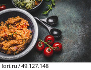 Healthy vegetarian couscous salad in bowl on rustic background, top view, close up, border.  Diet eating, Vegetarian or vegan food concept. Стоковое фото, агентство Ingram Publishing / Фотобанк Лори