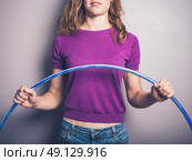 A young woman is holding a hula hoop. Стоковое фото, агентство Ingram Publishing / Фотобанк Лори
