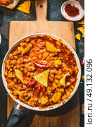 Chili Con Carne in cooking pan  with tortilla chips , top view. Стоковое фото, агентство Ingram Publishing / Фотобанк Лори
