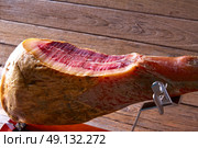 Iberian ham pata negra from Spain cut by hand on wood. Стоковое фото, агентство Ingram Publishing / Фотобанк Лори