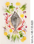Raw flounder fish with fresh seasoning,lemon and spices on  withe rustic wooden background, top view. Стоковое фото, агентство Ingram Publishing / Фотобанк Лори