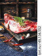 Raw meat mutton. Raw meat lamb shoulder blade on the kitchen board. Стоковое фото, агентство Ingram Publishing / Фотобанк Лори