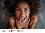 A woman sticking out her tongue in a humorous expression. Стоковое AI-изображение, AI-художник Данила Большаков / Фотобанк Лори