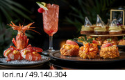 A table is filled with plates of food and drinks, ready to be enjoyed by diners. Стоковое AI-изображение, AI-художник Данила Большаков / Фотобанк Лори