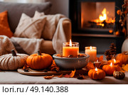 A snug fall haven, where the atmosphere is rich with the aroma of baked pumpkin treats and the soothing flicker of candles. Стоковое AI-изображение, AI-художник Ирина Старикова / Фотобанк Лори