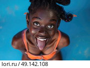 A woman with her mouth open and tongue out, displaying a playful expression. Стоковое AI-изображение, AI-художник Данила Большаков / Фотобанк Лори