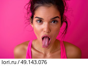 A woman standing with her tongue sticking out in a humorous expression. Стоковое AI-изображение, AI-художник Данила Большаков / Фотобанк Лори