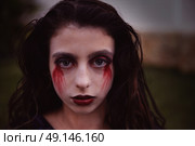 Halloween kid girl custome with bloody makeup on backyard turf. Стоковое фото, агентство Ingram Publishing / Фотобанк Лори