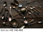 Vintage retro tea spoons and Strainers silver  on wooden background. Стоковое фото, агентство Ingram Publishing / Фотобанк Лори
