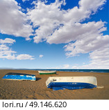 Valencia La Malvarrosa beach arenas beached boats in Spain. Стоковое фото, агентство Ingram Publishing / Фотобанк Лори