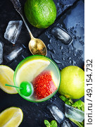 freshly squeezed citrus juice. summer cocktail of fresh lime juice,orange on dark blue background. Стоковое фото, агентство Ingram Publishing / Фотобанк Лори