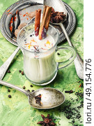 Masala tea ingredients. glass of Indian tonic tea with milk and spicy spices. Стоковое фото, агентство Ingram Publishing / Фотобанк Лори