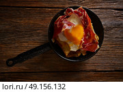 Tapas huevos rotos broken eggs with ham and yolk from Spain. Стоковое фото, агентство Ingram Publishing / Фотобанк Лори