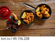 Fish seafood tapas adobo squid and steamed mussels of spain. Стоковое фото, агентство Ingram Publishing / Фотобанк Лори