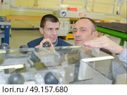 workers using press machine in paper factory. Стоковое фото, агентство Ingram Publishing / Фотобанк Лори