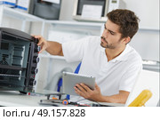 attractive repairman concentrated at work. Стоковое фото, агентство Ingram Publishing / Фотобанк Лори