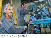 fixing a tractor. Стоковое фото, агентство Ingram Publishing / Фотобанк Лори