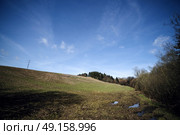 Landscape with hills and trees with blue sky and pylons on top of the field. Стоковое фото, агентство Ingram Publishing / Фотобанк Лори