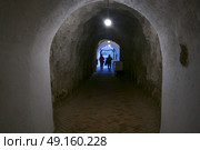 People walking through illuminated tunnel, Aragonese Castle, Ischia Island, Campania, Italy. Стоковое фото, агентство Ingram Publishing / Фотобанк Лори