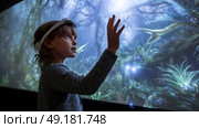 Child using virtual reality headset for metaverse, child looking into VR glasses. Little girl boy with futuristic glasses having fun, teenager playing video games. Technology, simulator, oculus future. Стоковое AI-изображение, AI-художник ALLA YURTAYEVA / Фотобанк Лори