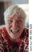 An older woman wrinkles her face into a funny expression, eyes wide open in a comedic gesture. Стоковое AI-изображение, AI-художник Данила Большаков / Фотобанк Лори
