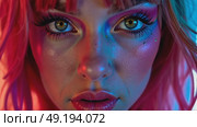 A close-up of a woman with vibrant, colorful makeup and color hair, her intense gaze directed at the camera, bright pink, magenta, yellow, blue, red laser neon lights flashes in the background. Стоковое AI-видео, аниматор Sergey Grishin / Фотобанк Лори