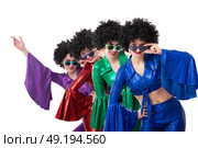 A group of girls in colorful flared suits and afro wigs pose against a white background. Disco style from the eighties or seventies. Стоковое фото, фотограф Лазаренко Светлана / Фотобанк Лори