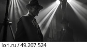 A man in a suit and hat stands confidently in front of a microphone, ready to address an audience. Стоковое AI-изображение, AI-художник Данила Большаков / Фотобанк Лори