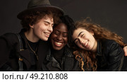 A diverse group of young individuals standing closely together in a unified pose for a group photo. Стоковое AI-изображение, AI-художник Данила Большаков / Фотобанк Лори