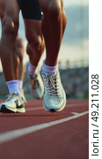 A close-up of a sprinter's feet on starting blocks, their muscles tense and ready, the stadium lights reflecting off their polishes legs. Стоковое AI-видео, аниматор Sergey Grishin / Фотобанк Лори