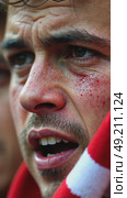 A close-up of a fan's face streaked with emotions of disappointment, their team's scarf clutched tightly, big sport stadium full. Стоковое AI-видео, аниматор Sergey Grishin / Фотобанк Лори