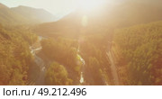 Low altitude flight over fresh fast mountain river with rocks at sunny summer morning. Стоковое видео, видеограф Александр Маркин / Фотобанк Лори