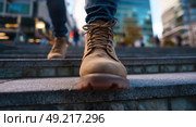 A person wearing brown boots is walking up a set of stairs. Стоковое AI-изображение, AI-художник Ярославский Максим / Фотобанк Лори