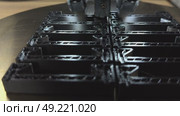 3 d printer makes prints parts from black plastic material,3D printer in operation close-up. Automatic three dimensional 3d printing performs plastic modeling in laboratory. The 4ht industrial. Стоковое видео, видеограф Куликов Константин / Фотобанк Лори