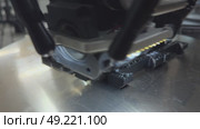 3 d printer makes prints parts from black plastic material,3D printer in operation close-up. Automatic three dimensional 3d printing performs plastic modeling in laboratory. The 4ht industrial. Стоковое видео, видеограф Куликов Константин / Фотобанк Лори