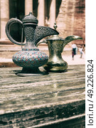 in the site of petra jordan the traditional coffe container isolated on a table. Стоковое фото, агентство Ingram Publishing / Фотобанк Лори