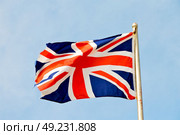 waving flag in the blue sky british colour and wave. Стоковое фото, агентство Ingram Publishing / Фотобанк Лори
