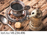 Coffee mug in the oriental style. Vintage cup of coffee on saucer in oriental style. Стоковое фото, агентство Ingram Publishing / Фотобанк Лори