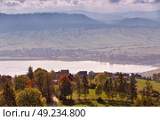 Lake behind foothills of tatra mountains. Village on lakeside.  Malopolska, Poland. Стоковое фото, агентство Ingram Publishing / Фотобанк Лори