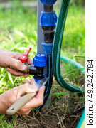 Installing an additional tap for draining drip irrigation. Fitting the tap for insertion into the pipe. Стоковое фото, фотограф Коханова Наталья / Фотобанк Лори