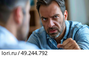 A man standing pointedly accusingly at another man. Стоковое AI-изображение, AI-художник Данила Большаков / Фотобанк Лори