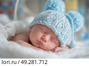 A baby is sleeping with a blue hat on. Стоковое AI-изображение, AI-художник Ярославский Максим / Фотобанк Лори