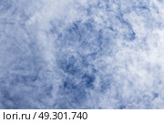 Wispy white clouds against a vibrant blue sky create a serene mood. Стоковое фото, фотограф EugeneSergeev / Фотобанк Лори