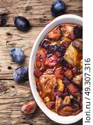 stew meat in plum sauce. meat stew in sauce of autumn plums on a retro background. Стоковое фото, агентство Ingram Publishing / Фотобанк Лори