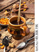 tea with sea-buckthorn. autumn sea-buckthorn tea on an old vintage wooden background. Стоковое фото, агентство Ingram Publishing / Фотобанк Лори