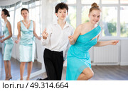 Motivated couple of teen dancers practicing vigorous Lindy Hop. Стоковое фото, фотограф Яков Филимонов / Фотобанк Лори