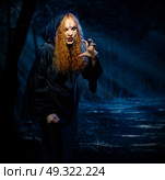 Scary witch in night forest. Стоковое фото, агентство Ingram Publishing / Фотобанк Лори